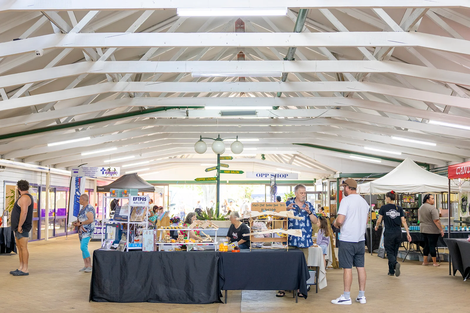 Stallholders and visitors inside the market