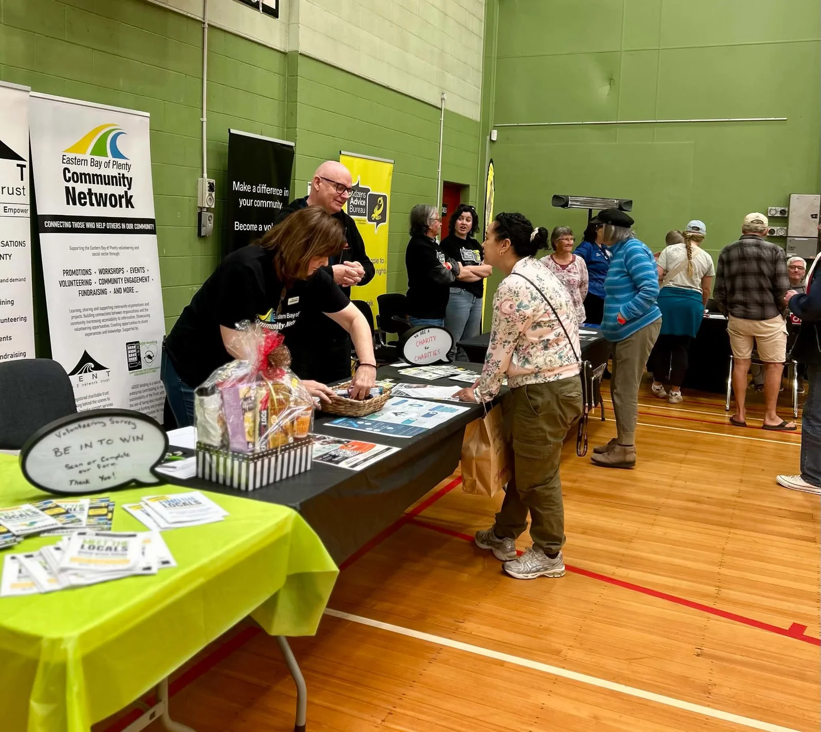 Visitors talking with community groups at their stands
