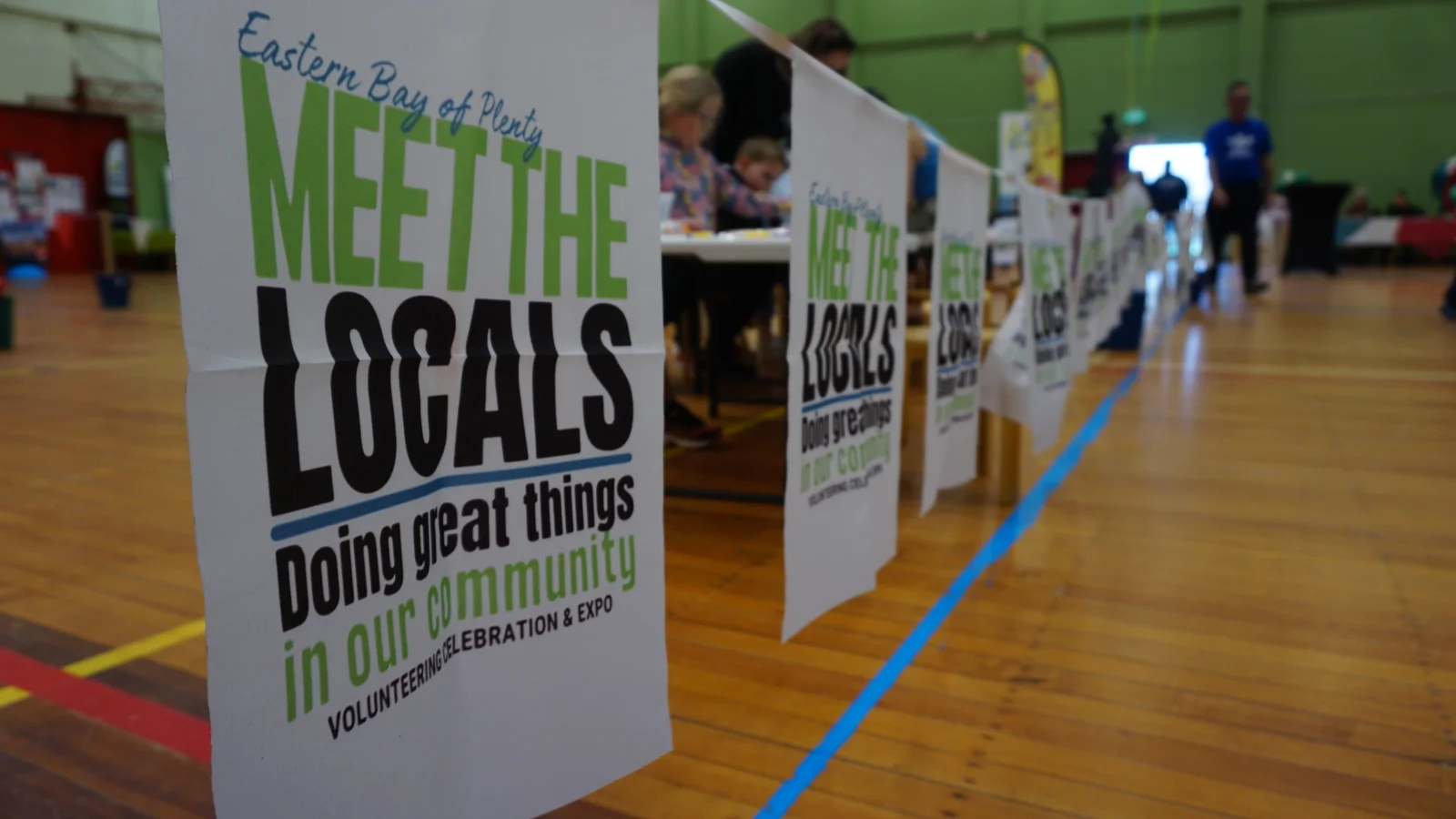 Meet the Locals signs beside the community stands